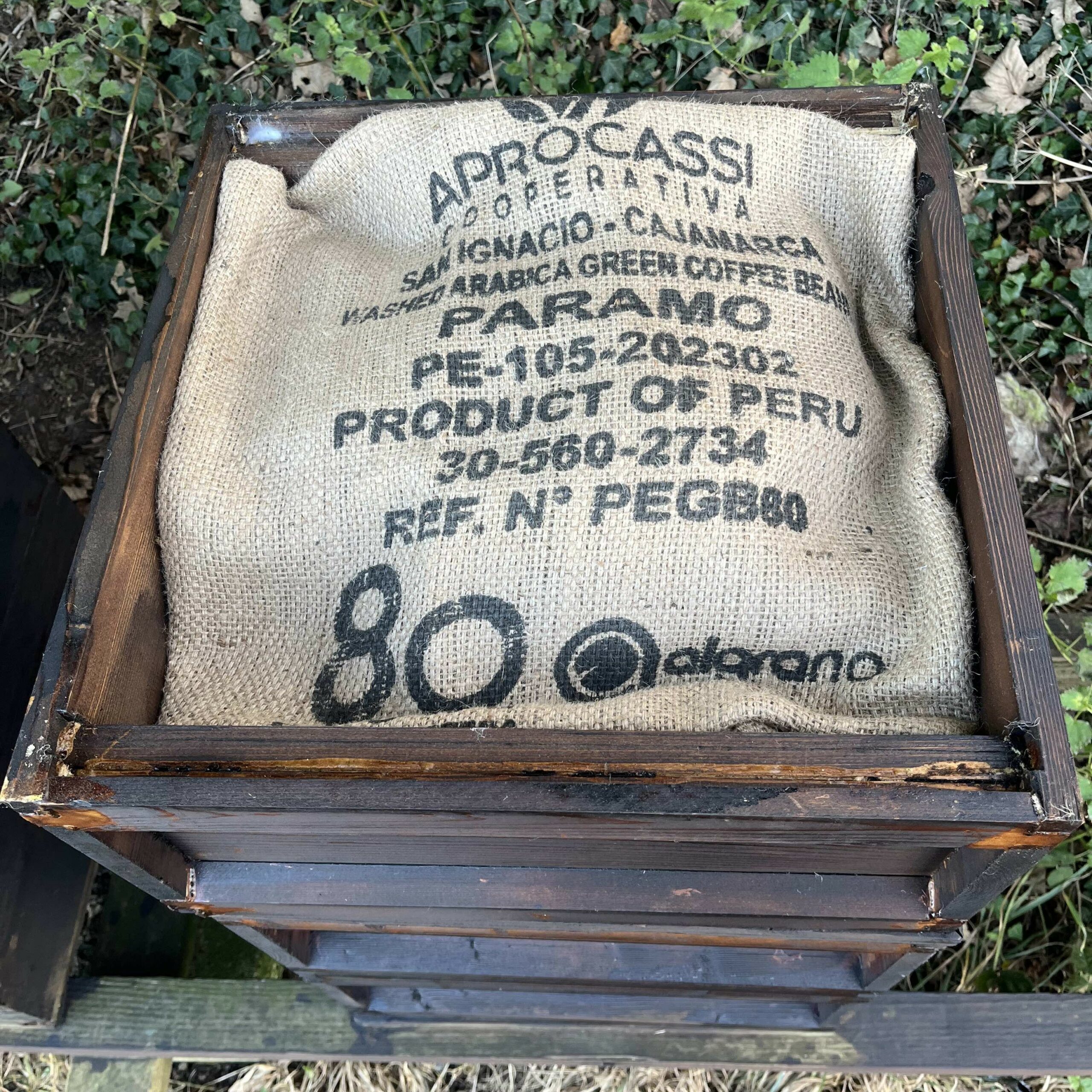 jute coffee sack covering a beehive in winter